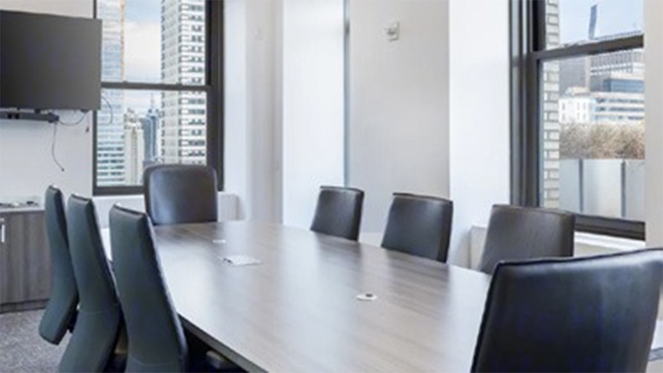 Conference room at 220 E 42nd which includes 8 chairs and large screen tv